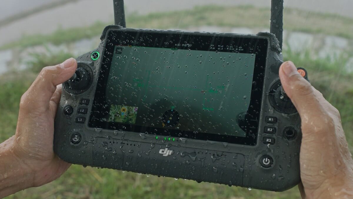 DJI RC Plus weather-resistant smart controller being used in rain
