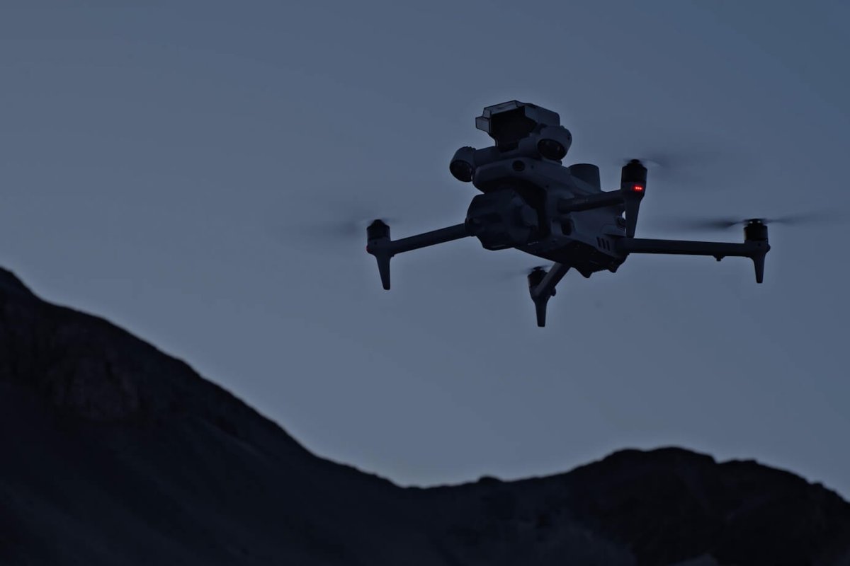 DJI Matrice enterprise drone flying against low light sky